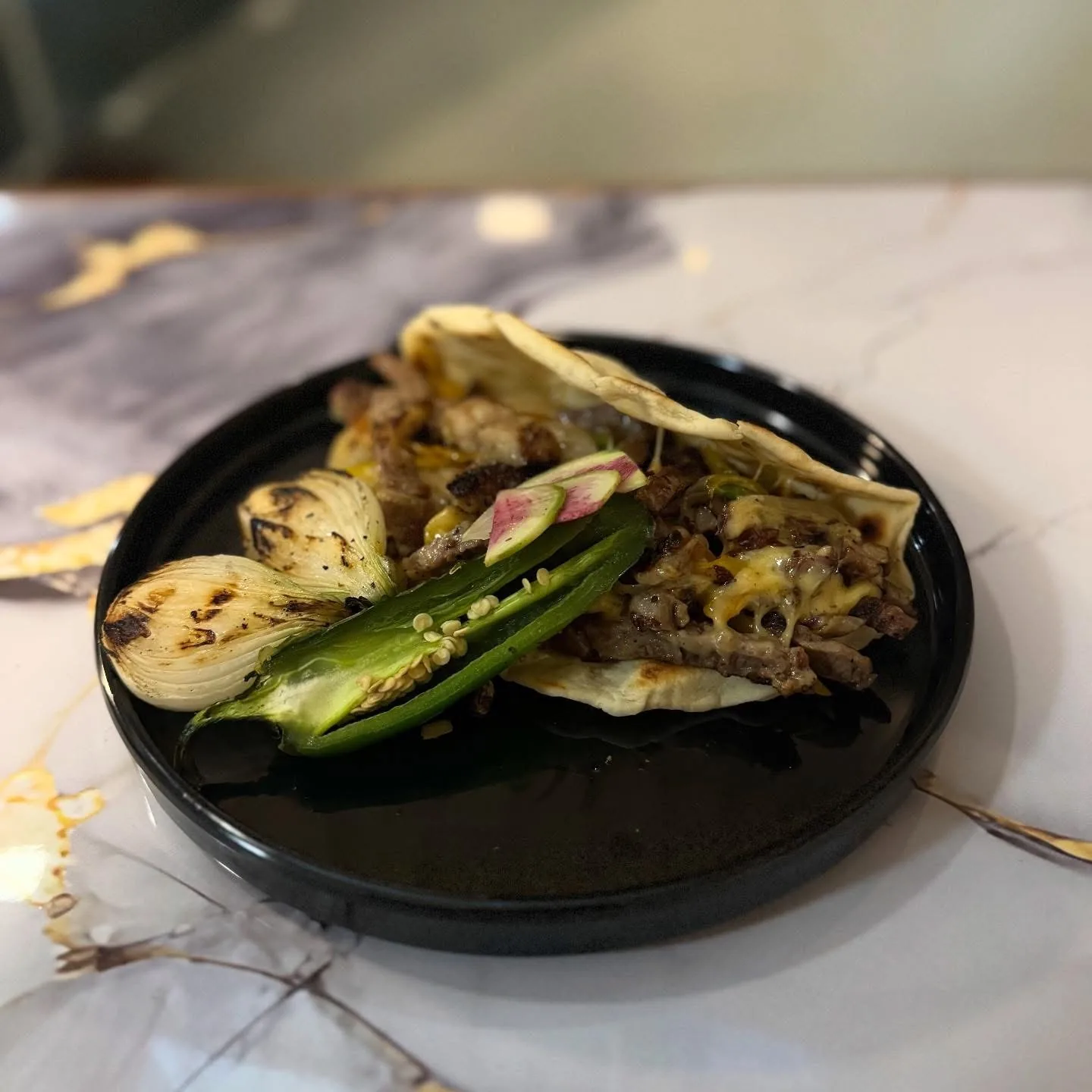 Taco de carne con cebollitas y chile